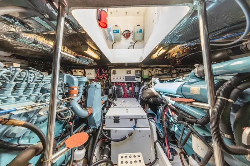 Slide: The Image of Engine room of a 2000 Tiara Yachts 4000 Express, showcasing complex machinery and wiring. - 34