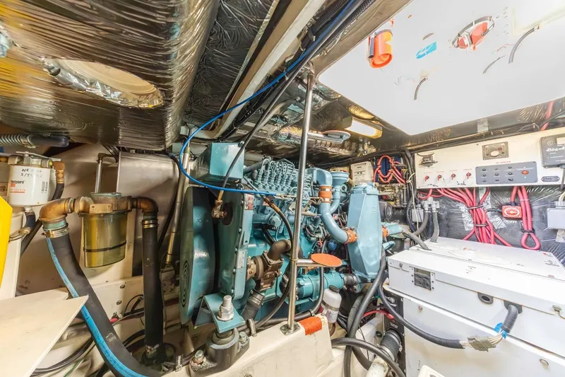 Slide: The Image of Engine room of 2000 Tiara Yachts 4000 Express, showcasing complex machinery and wiring. - 35