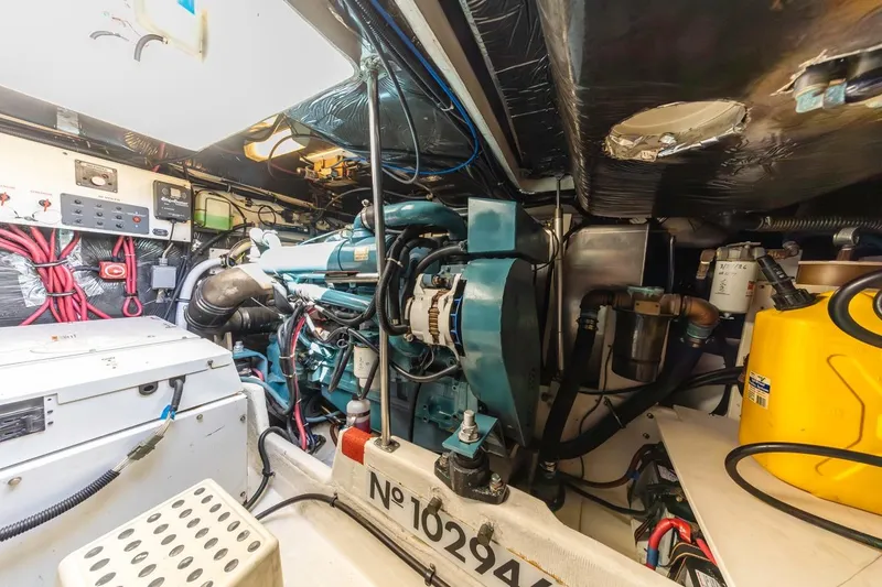 Slide: The Image of Engine room of a 2000 Tiara Yachts 4000 Express, showcasing mechanical components and wiring. - 36