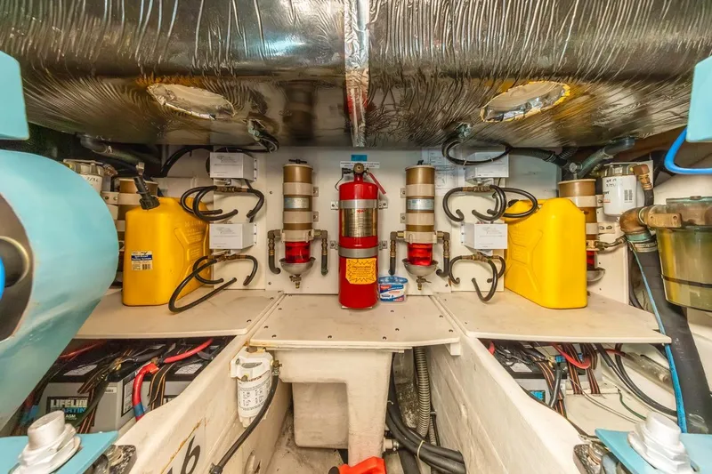 Slide: The Image of Engine room of a 2000 Tiara Yachts 4000 Express, showcasing machinery and wiring. - 37