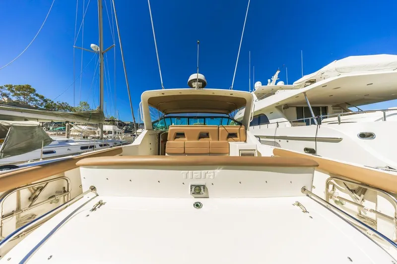 Slide: The Image of 2000 Tiara Yachts 4000 Express docked, showcasing spacious deck and sleek design. - 7