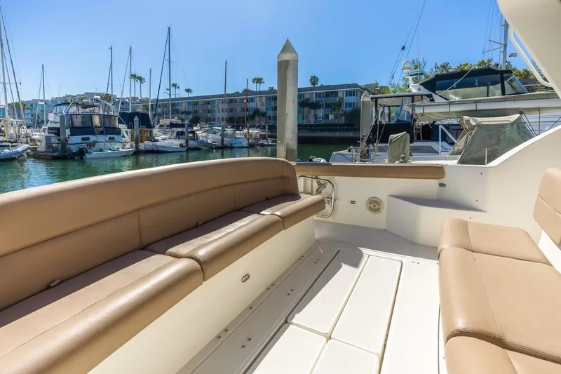 Slide: The Image of 2000 Tiara Yachts 4000 Express with tan seating in a marina setting. - 8