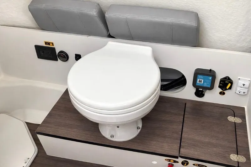 Slide: The Image of 2024 Beneteau Flyer 8 SPACEdeck boat toilet area with control panel and storage. - 10