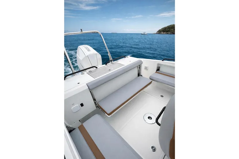Slide: The Image of 2024 Beneteau Flyer 8 SPACEdeck interior with seating, overlooking serene ocean waters. - 8