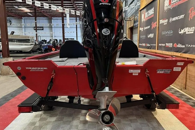 Slide: The Image of 2026 Tracker Pro Team 195 Tournament Edition boat in showroom, rear view with motor. - 6