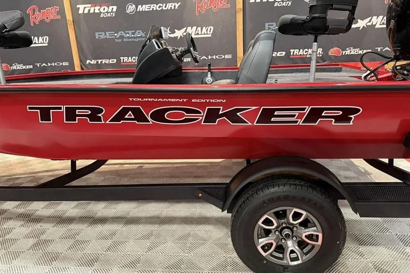 Slide: The Image of 2026 Tracker Pro Team 195 Tournament Edition boat, red with bold branding, on display. - 8
