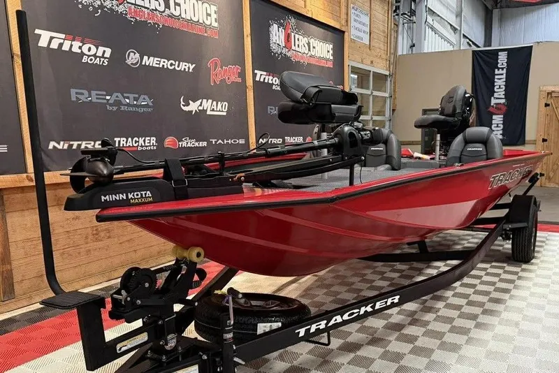 Slide: The Image of 2026 Tracker Pro Team 195 Tournament Edition boat displayed indoors on a trailer. - 9
