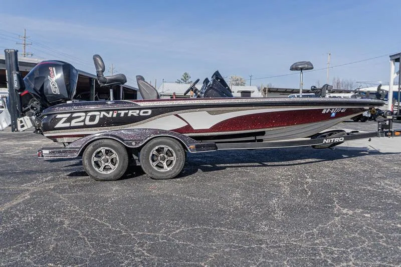 The Image of 2019 Nitro Z20 Pro bass boat on trailer, side view in parking lot. - 1