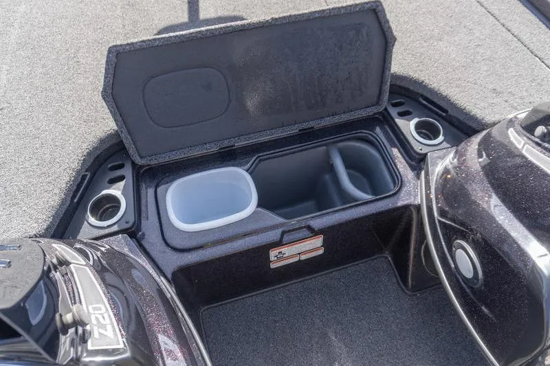 Slide: The Image of 2019 Nitro Z20 Pro boat storage compartment with cup holders and open lid. - 12