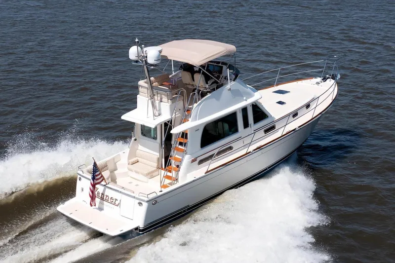 The Image of 2016 Sabre 42 Fly Bridge Sedan cruising on open water. - 0