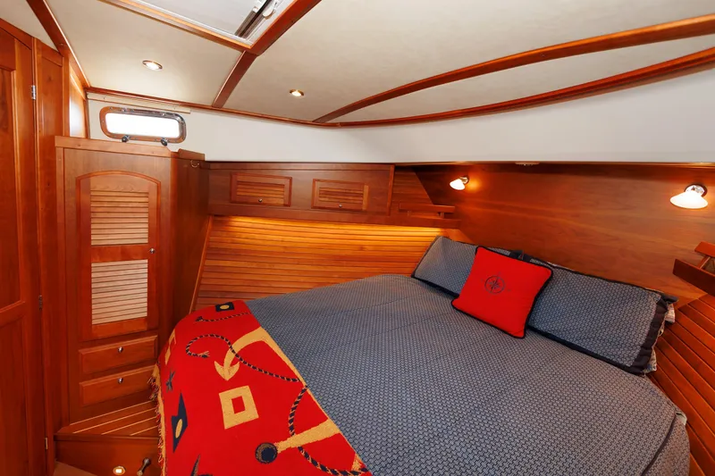 Slide: The Image of Luxurious cabin interior of 2016 Sabre 42 Fly Bridge Sedan with cozy bedding and wooden accents. - 16