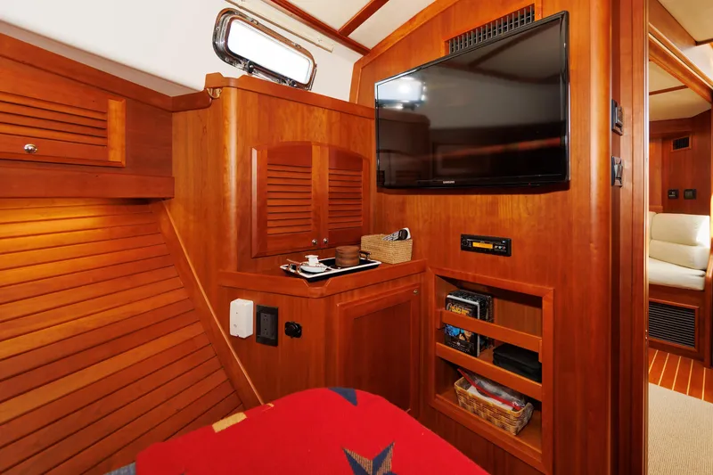 Slide: The Image of Luxurious interior of 2016 Sabre 42 Fly Bridge Sedan with wood paneling and TV. - 17