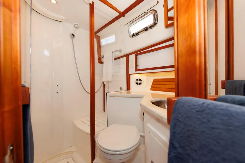 Slide: The Image of Luxurious bathroom interior of 2016 Sabre 42 Fly Bridge Sedan yacht, featuring wood accents. - 19