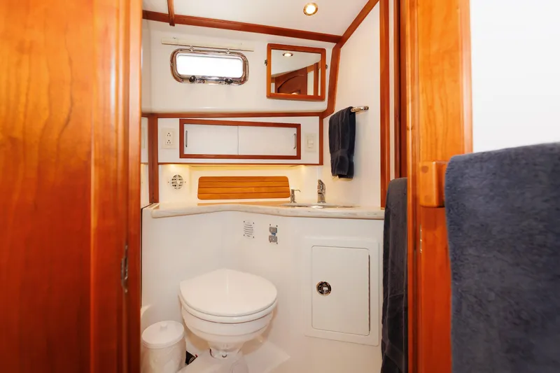 Slide: The Image of 2016 Sabre 42 Fly Bridge Sedan bathroom with wood accents and modern fixtures. - 20