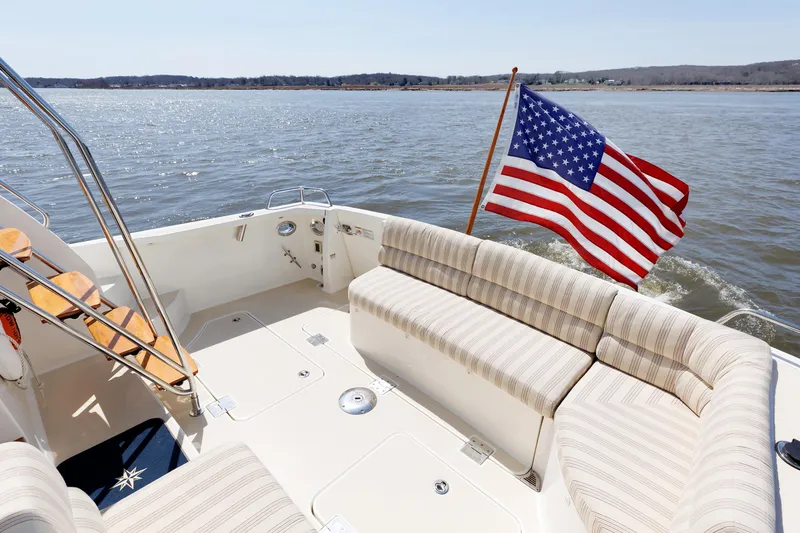 Slide: The Image of 2016 Sabre 42 Fly Bridge Sedan with American flag on water. - 21