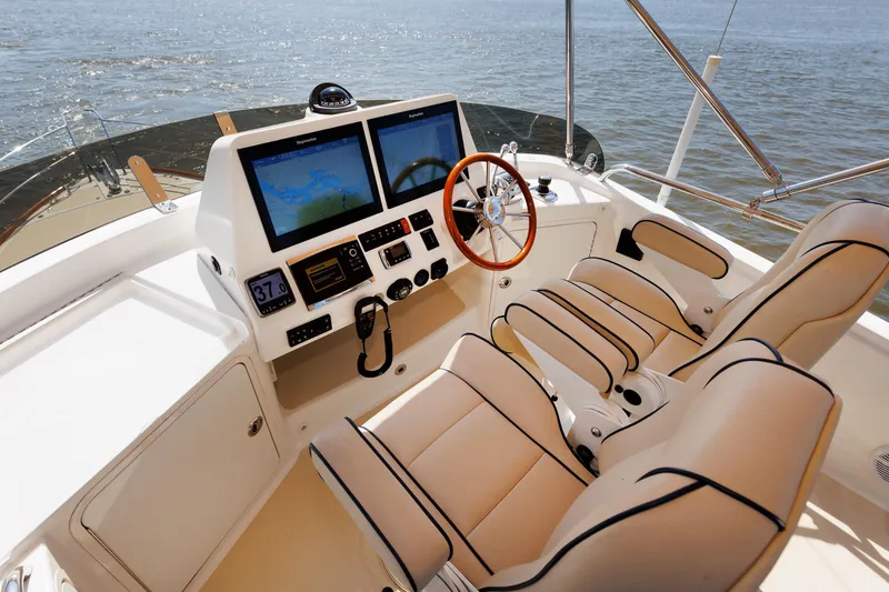 Slide: The Image of Helm of 2016 Sabre 42 Fly Bridge Sedan with dual screens and leather seats. - 26