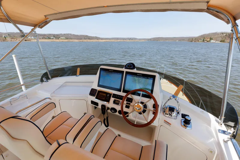 Slide: The Image of Helm of 2016 Sabre 42 Fly Bridge Sedan with dual navigation screens on open water. - 27