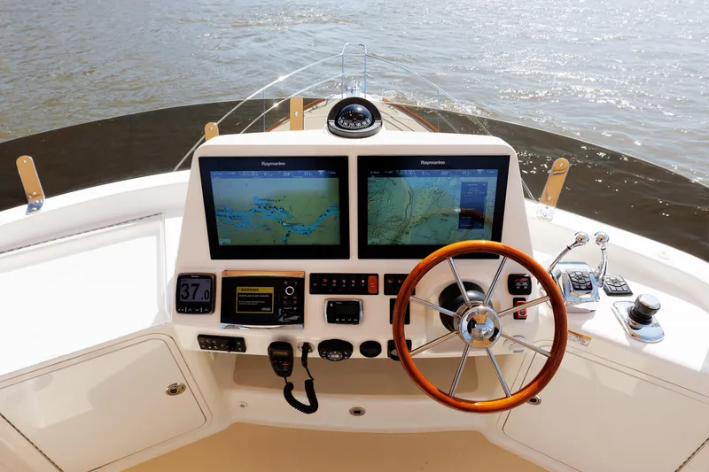 Slide: The Image of Helm of 2016 Sabre 42 Fly Bridge Sedan with navigation screens and controls. - 29