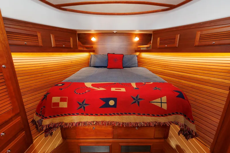 Slide: The Image of Luxurious cabin interior of 2016 Sabre 42 Fly Bridge Sedan with nautical-themed bedding. - 3