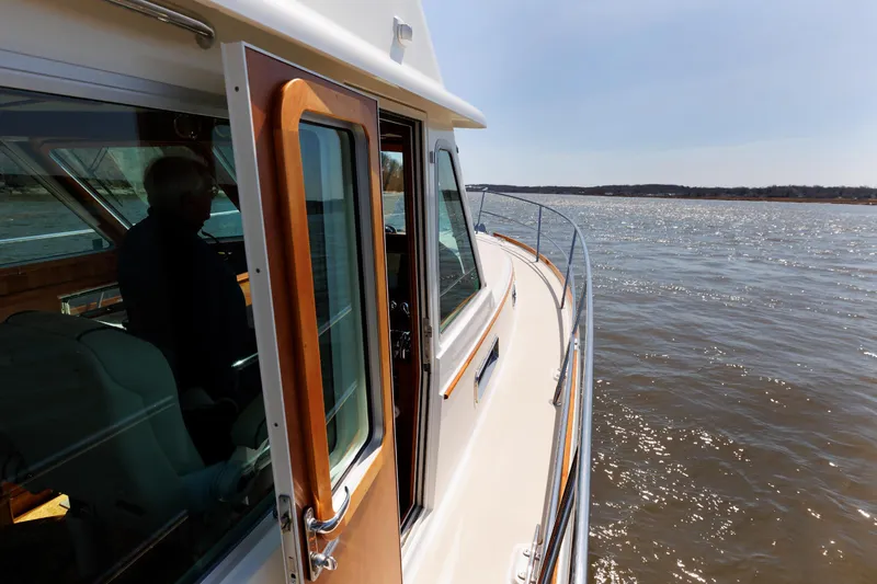 Slide: The Image of 2016 Sabre 42 Fly Bridge Sedan cruising on open water. - 31