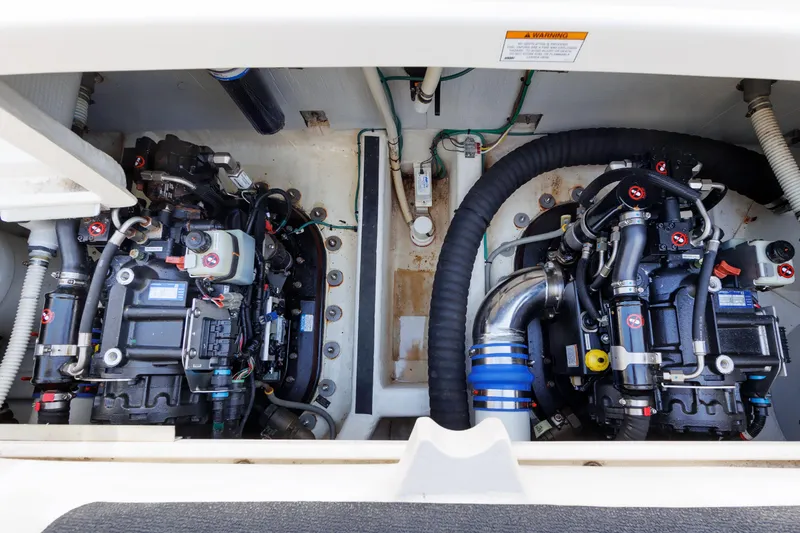 Slide: The Image of Engine compartment of 2016 Sabre 42 Fly Bridge Sedan, showcasing dual engines and mechanical components. - 37