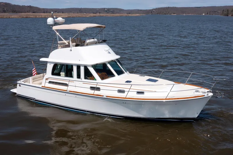 Slide: The Image of 2016 Sabre 42 Fly Bridge Sedan cruising on a calm lake. - 39