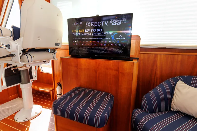 Slide: The Image of Interior of 2016 Sabre 42 Fly Bridge Sedan with TV and striped seating. - 6