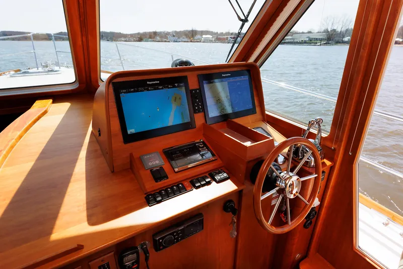 Slide: The Image of Helm of 2016 Sabre 42 Fly Bridge Sedan with navigation screens and steering wheel. - 8