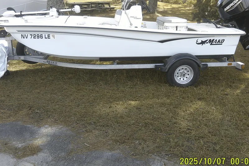The Image of 2024 Mako Pro Skiff 15 CC boat on trailer, parked on grass. - 0