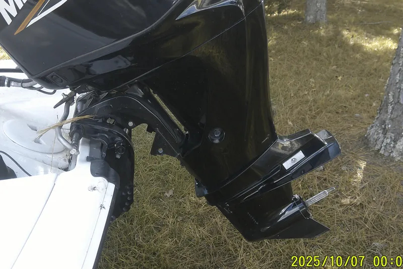 Slide: The Image of Outboard motor of 2024 Mako Pro Skiff 15 CC on grassy ground. - 13