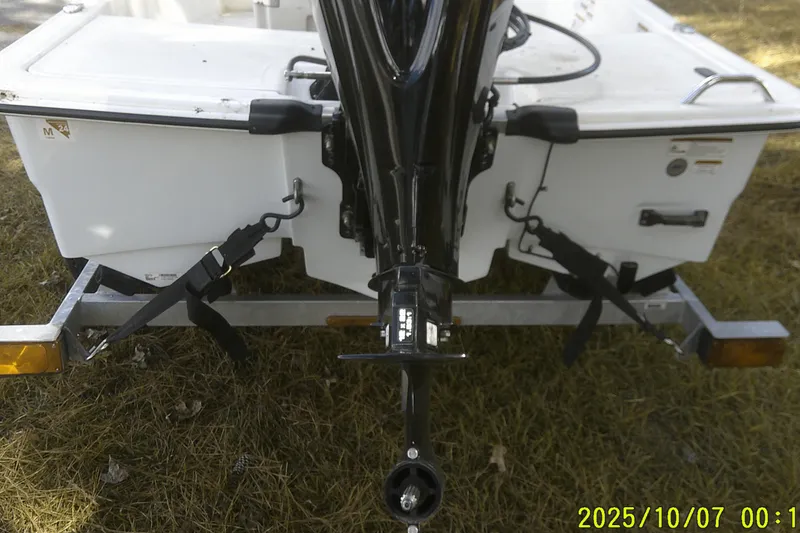 Slide: The Image of Rear view of 2024 Mako Pro Skiff 15 CC on trailer, showing motor and hull. - 15