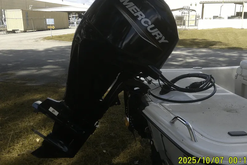 Slide: The Image of 2024 Mako Pro Skiff 15 CC with Mercury outboard motor in outdoor setting. - 16