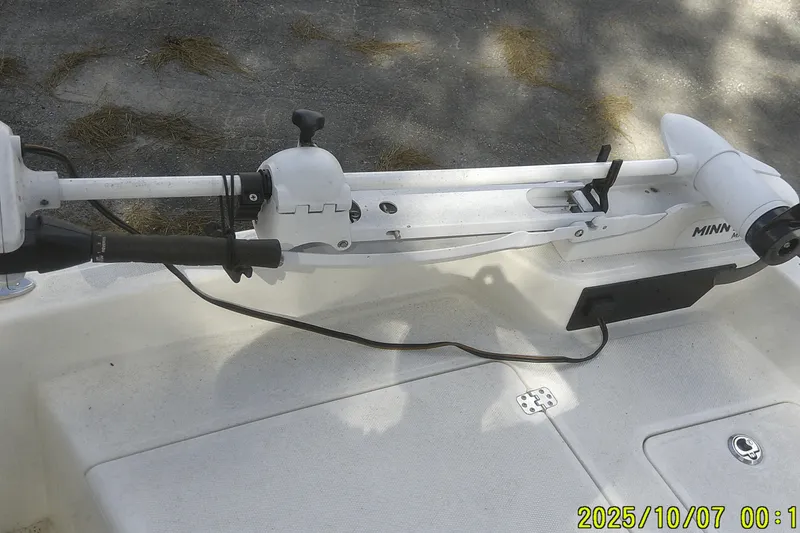 Slide: The Image of 2024 Mako Pro Skiff 15 CC with Minn Kota trolling motor on deck. - 21