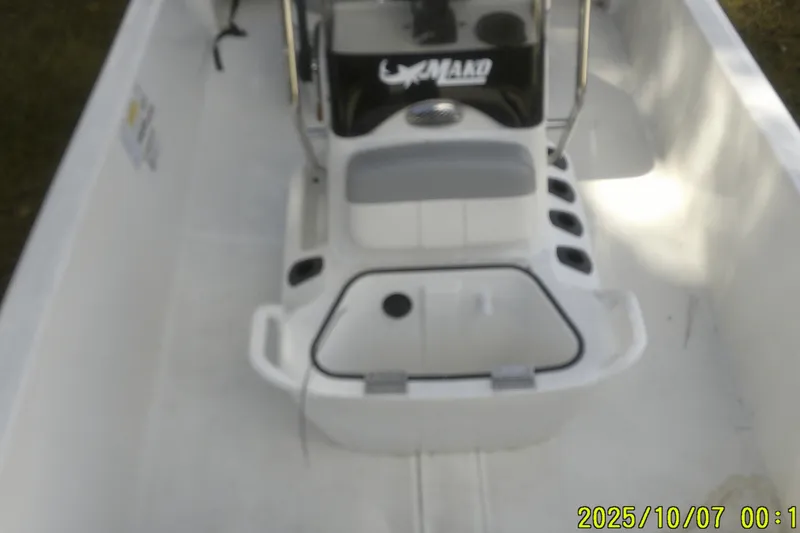 Slide: The Image of 2024 Mako Pro Skiff 15 CC boat interior with console and seating. - 22