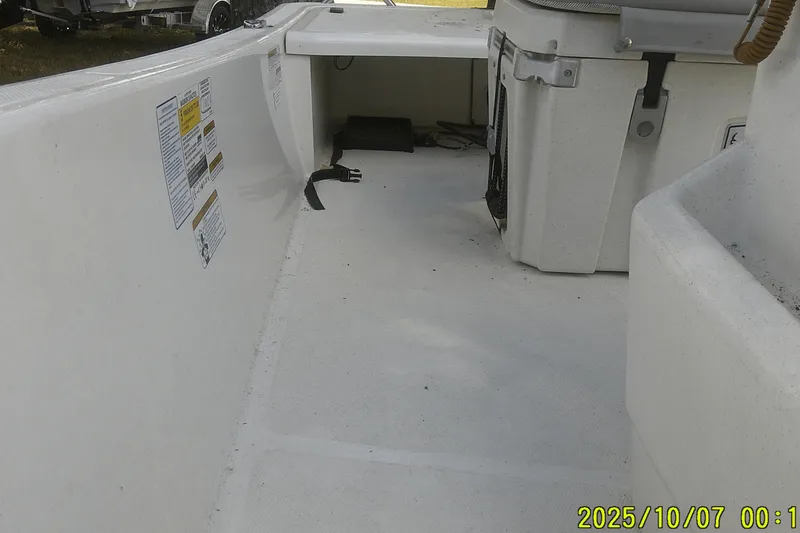 Slide: The Image of 2024 Mako Pro Skiff 15 CC interior view with storage and equipment. - 25