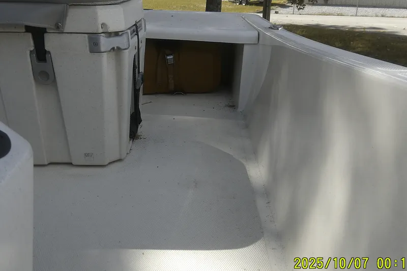 Slide: The Image of 2024 Mako Pro Skiff 15 CC interior view, showcasing seating and storage area. - 26