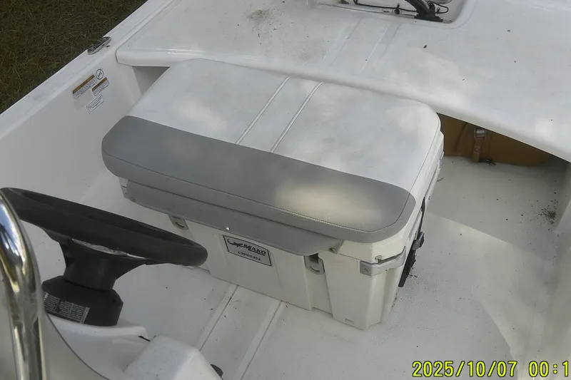 Slide: The Image of 2024 Mako Pro Skiff 15 CC interior with steering wheel and cushioned seat. - 27