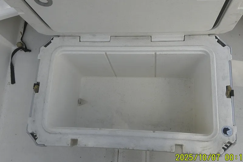 Slide: The Image of Open storage compartment on 2024 Mako Pro Skiff 15 CC boat. - 28