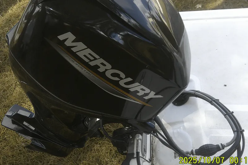 Slide: The Image of Outboard motor on a 2024 Mako Pro Skiff 15 CC boat, featuring Mercury branding. - 31