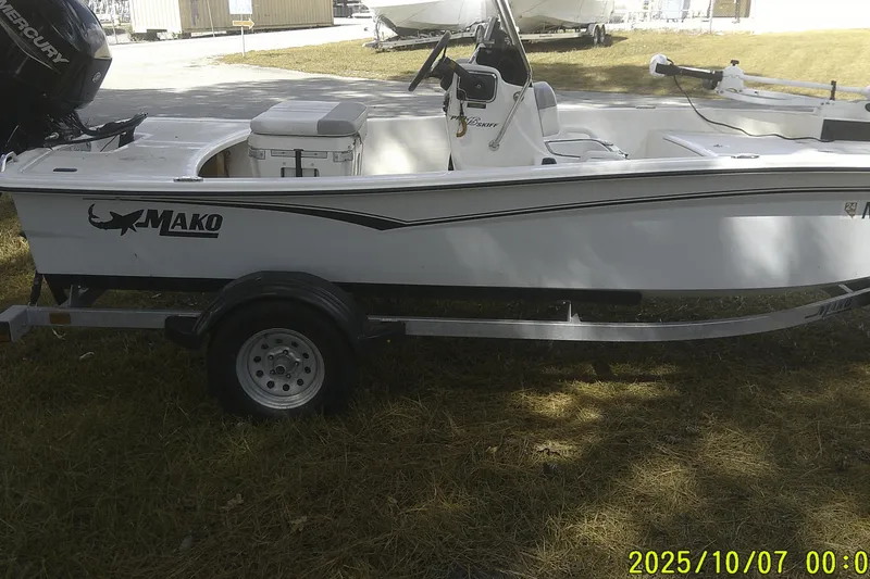 Slide: The Image of 2024 Mako Pro Skiff 15 CC boat on trailer, side view. - 8