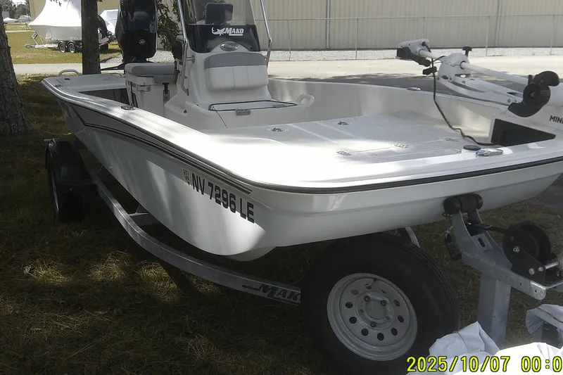 Slide: The Image of 2024 Mako Pro Skiff 15 CC boat on trailer, parked outdoors. - 9