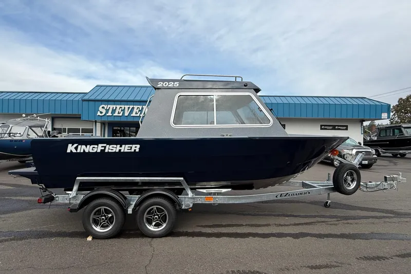 The Image of KingFisher 2025 Escape HTT boat on trailer, parked outside dealership, 2026 model. - 1