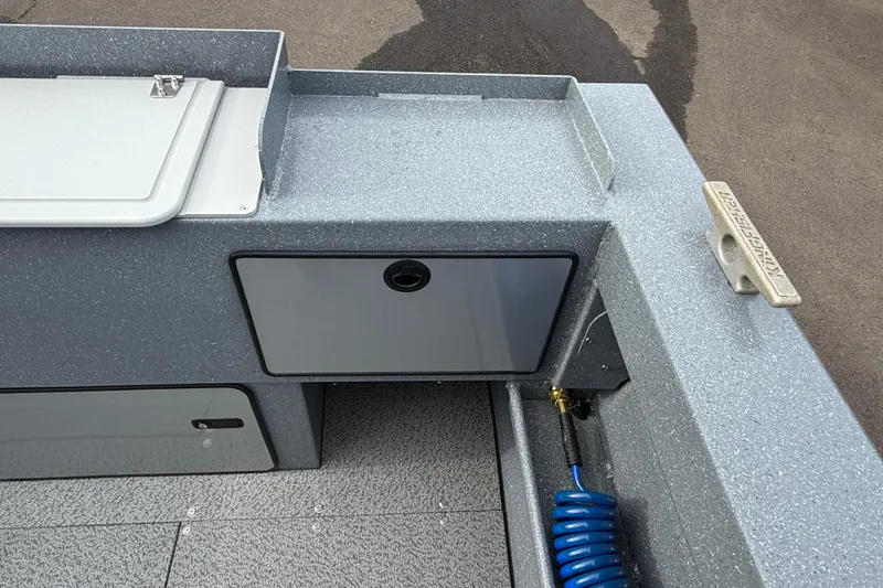 Slide: The Image of Interior view of 2026 KingFisher 2025 Escape HTT boat, featuring storage compartments and coiled hose. - 13