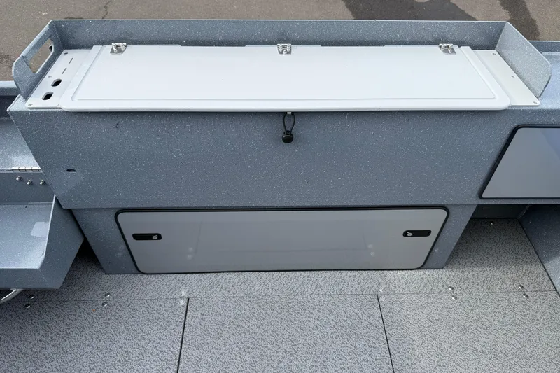 Slide: The Image of KingFisher 2025 Escape HTT boat storage compartment, 2026 model, with secure latches and textured finish. - 16