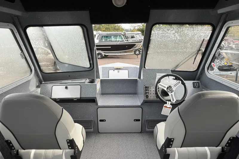 Slide: The Image of Interior of 2026 KingFisher 2025 Escape HTT boat with steering wheel and seating. - 24