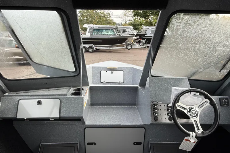 Slide: The Image of Interior view of 2026 KingFisher 2025 Escape HTT boat cockpit with steering wheel and controls. - 25