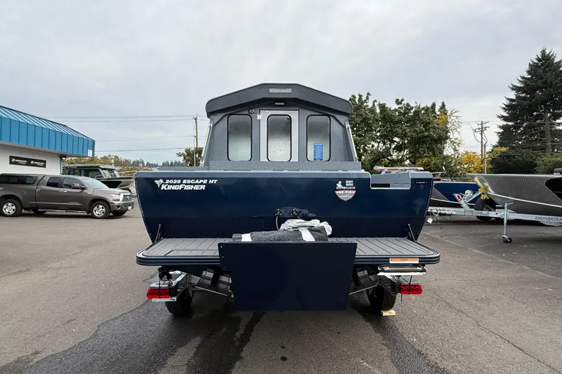 Slide: The Image of KingFisher 2026 Escape HTT boat, rear view in a parking lot setting. - 3