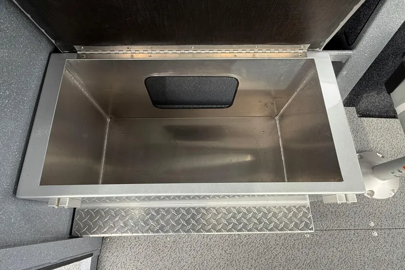 Slide: The Image of Storage compartment in 2026 KingFisher 2025 Escape HTT boat, featuring diamond plate flooring. - 36