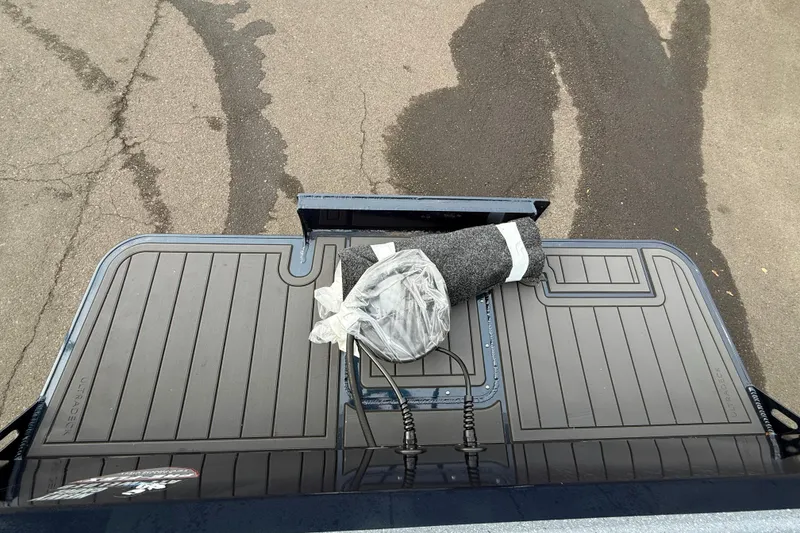 Slide: The Image of KingFisher 2025 Escape HTT boat deck with rolled carpet and accessories. - 37