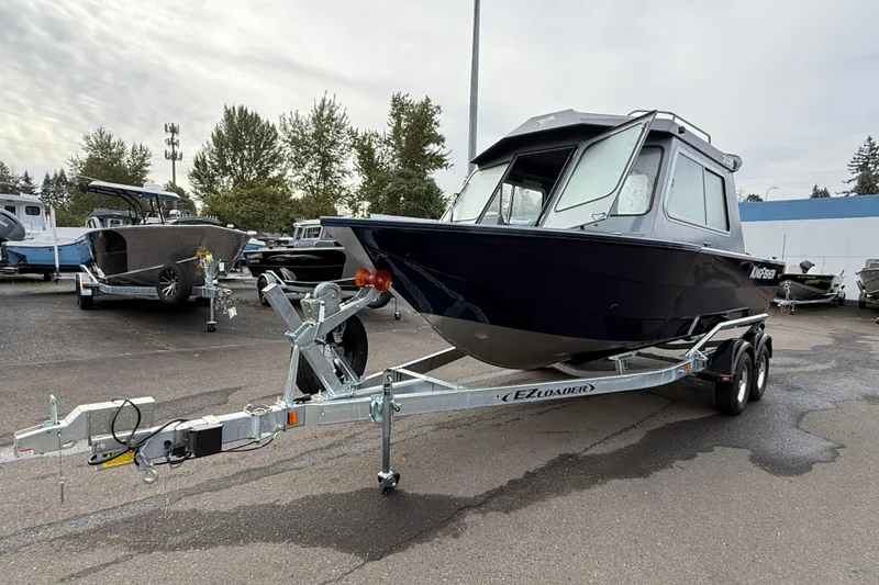 Slide: The Image of 2026 KingFisher 2025 Escape HTT boat on trailer in parking lot. - 4